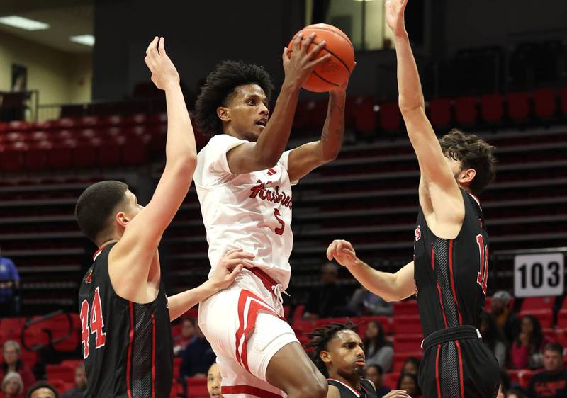 Northern Illinois' Philmon Gebrewhit goes to the basket between two Illinois Tech defenders during their game Monday, Nov. 13, 2023, at the NIU Convocation Center in DeKalb.