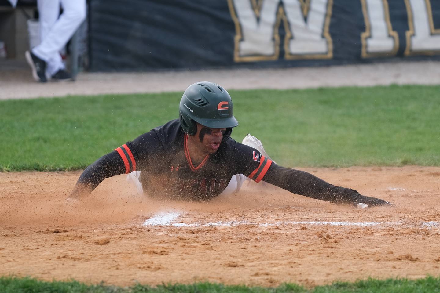 Plainfield East’s Christian Mitchelle slide home for the run against Plainfield Central. Monday, April 25, 2022, in Plainfield.