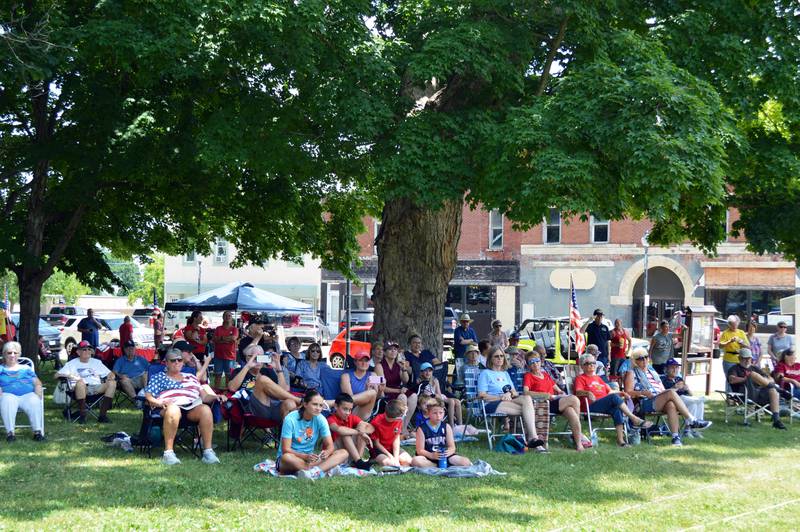 With a heat index of 93 degrees, those attending Mt. Morris' annual Let Freedom Ring patriotic program on July 4, 2023, avoided the direct sun and instead viewed the program from the shade of nearby trees. The program was held at noon on the Warren G. Reckmeyer Bandshell on the village's downtown campus.
