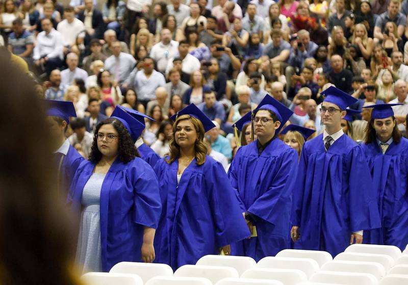 Wheaton North High School graduates stream into graduation ceremony Saturday, May 25, 2024 in the Physical Education Center of College of DuPage in Glen Ellyn.