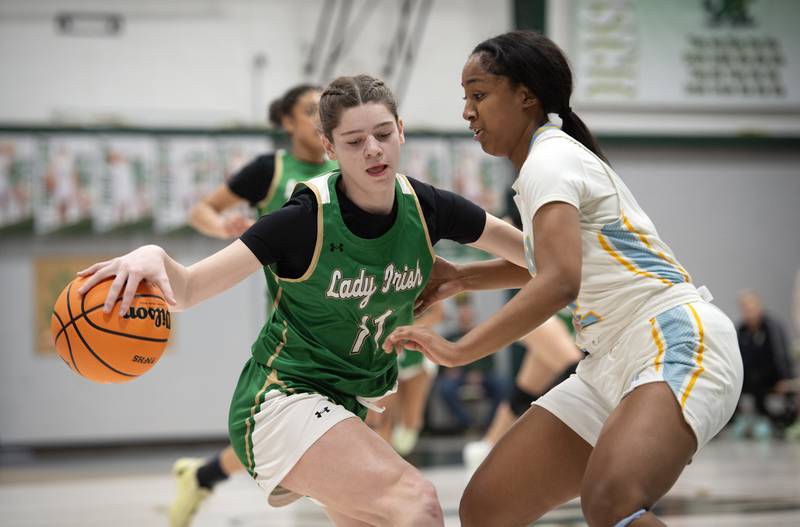 Bishop McNamara's Dylan Pallissard, left, controls the ball as Joliet Catholic's Gabrielle Gavin guards during the Class 2A Regional Championship on Thursday, Feb. 19, 2026.