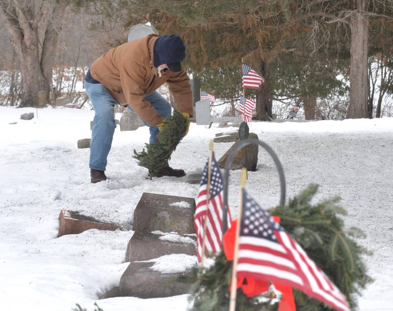 Veteran Don Stevens of Oregon lays a wreath at a veteran's grave at the Daysville Cemetery during the Wreaths Across America program on Saturday, Dec. 13, 2025.