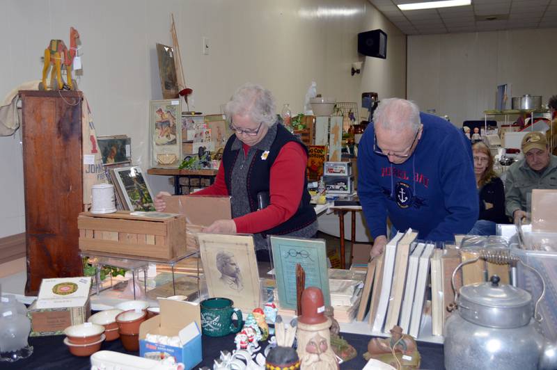 Molly and Ed Baker, of Mt. Morris, look through old newspapers and post cards during the annual February Finds Antique & Collectable Market on Feb. 4. The event was held at the Mt. Morris Moose Lodge 1551 Family Center and hosted more than 20 sellers.