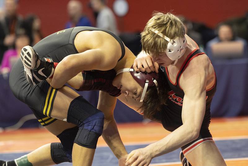 Riverdale’s Dean Wainwright (left) competes with Unity Christian’s Garrett VerHeecke in the 132 pound weight class of the 1A state individual wrestling finals Saturday, Feb. 22, 2025, at State Farm Center in Champaign.