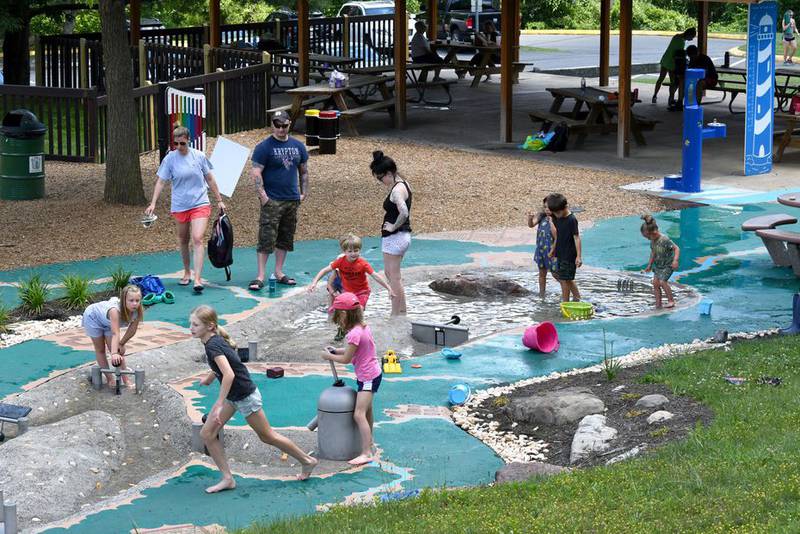 Photographs and designs, such as the playground shown here, are ideas for the "organic flow" concept for the planned Haligus Road park, shown at a meeting on Tuesday, March 1, 2022.