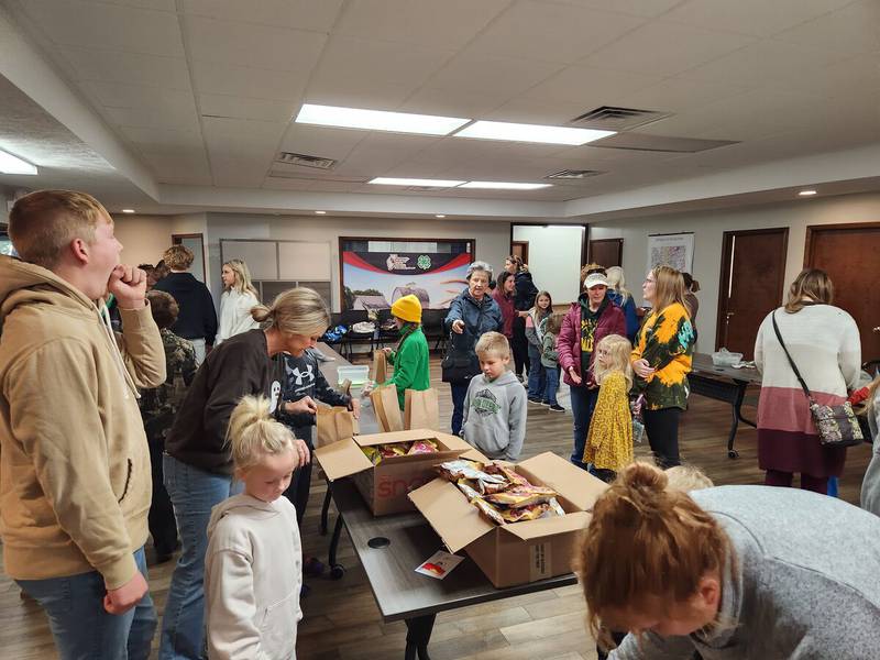 Volunteers hand out goodies to farmers as part of the University of Illinois Extension's volunteer event to thank farmers for their work during the harvest.