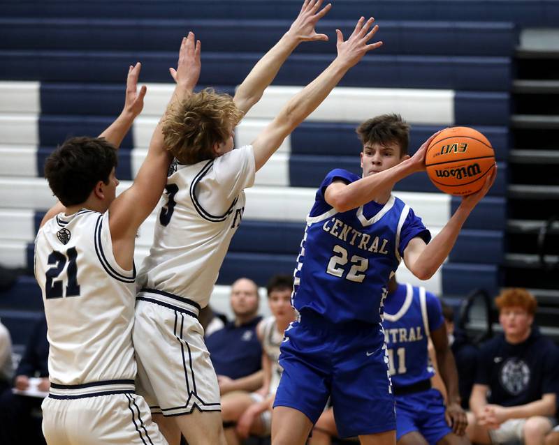 Burlington Central's Cash Cumpata (right) pass the ball past the defense of Cary-Grove's Brady Elbert (left) and Conner Strike (center) during a Fox Valley Conference  boys basketball game on Wednesday Jan. 7,  2026, at Cary-Grove High School, in Cary.