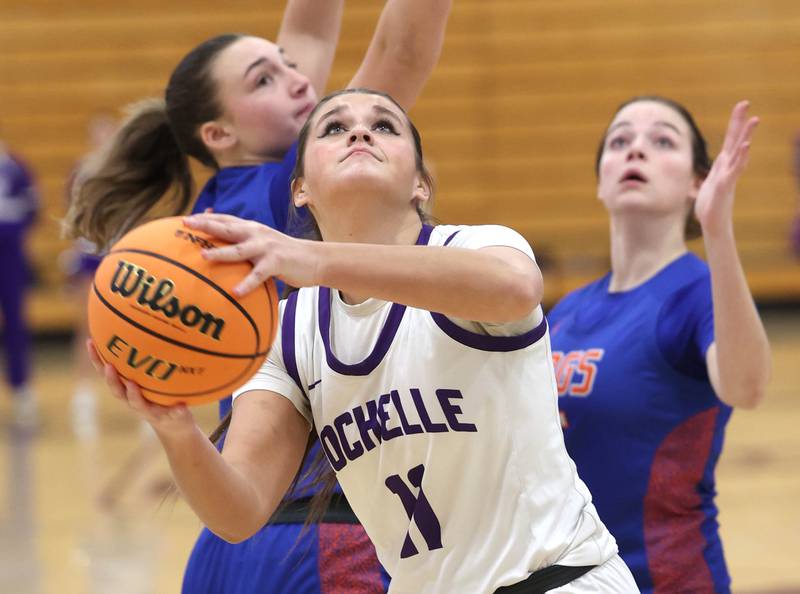 Rochelle's Audrina Rodriguez gets to the basket in front of two Genoa-Kingston defenders during their game Monday, Dec. 15, 2025, at Rochelle High School.