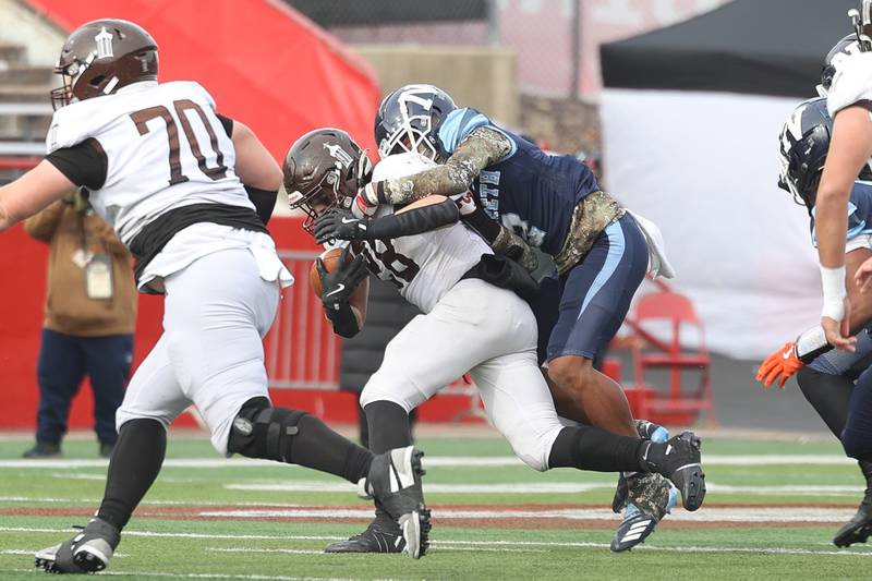 Joliet Catholic’s Nate Magrini carries a defender on a run against Nazareth in the Class 5A state championship on Saturday, Nov. 30, 2024 in Normal.