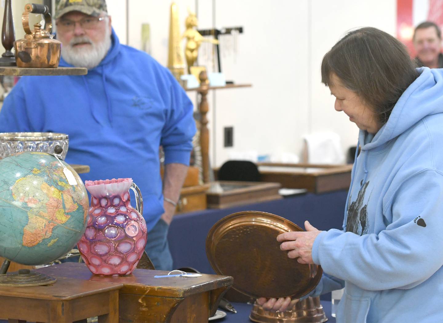 Linda and Don Pottinger of Oregon look at antiques in one of the 44 booths at the Oregon Woman's Club Antique Show on Saturday in Oregon.