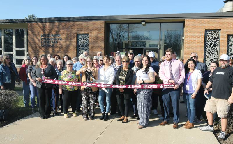 Tynisha Clegg, executive director of Family Service Agency, along with representatives from the city as well as staff and patrons of Club 55 prepare to cut the ribbon Monday, April 10, 2023, at the new location of Family Service Agency’s Club 55 in DeKalb. The senior center is celebrating its grand reopening in its new location at Bethlehem Lutheran Church, 1915 North First Street, in DeKalb.