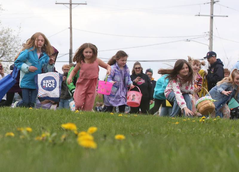 Kids race to find Easter eggs during the annual Easter egg hunt on Saturday, April 19, 225 at Carey Memorial Park in Utica.