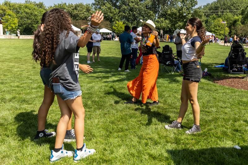 Necalli Cultural Movement dancers, Natalia Ortiz, Jaslene Del Toro, Maya Contreras, and Ayleen Del Torro, enjoy Barro Fest at Settlers' Park in Plainfield on July 27, 2024.
