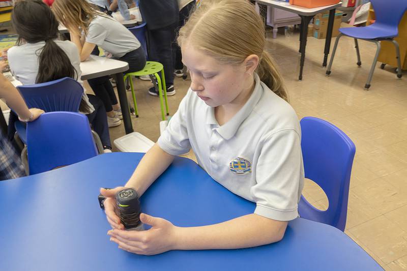 Ophelia Lumzy, a sixth grader at St. Anne’s School, controls a spinning robot Thursday, March 6, 2025, during the STREAM event. The robot is made up of cubes that each have different properties; the challenge is to find the correct placement build to meet a planned result.