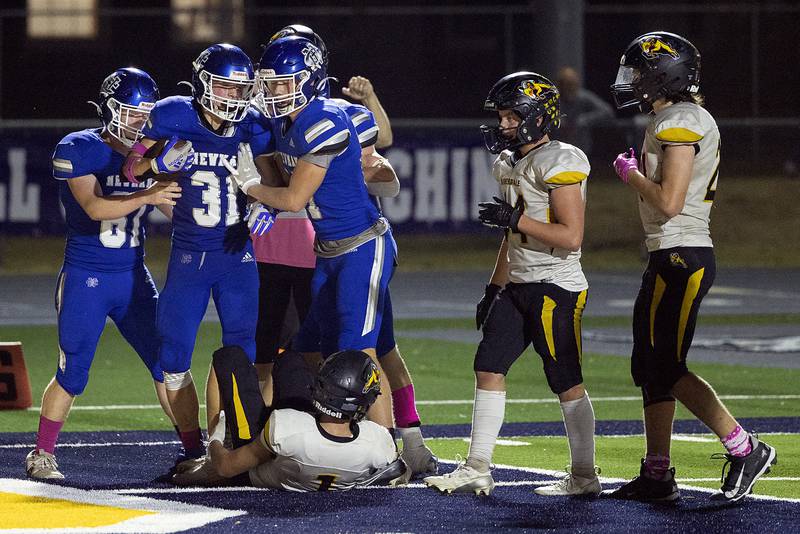 Newman’s Cody McBride celebrates a TD with teammates against Riverdale Friday, October 11, 2024, in Sterling.