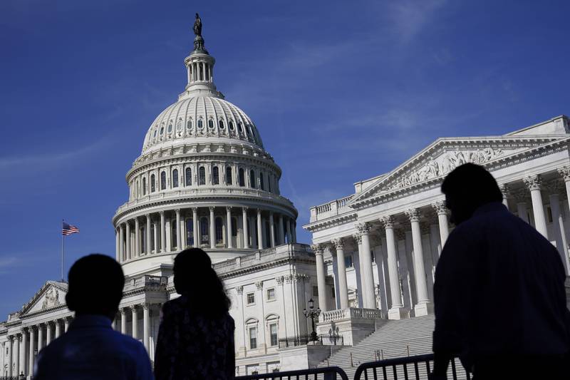 People walk outside the U.S Capitol building in Washington.