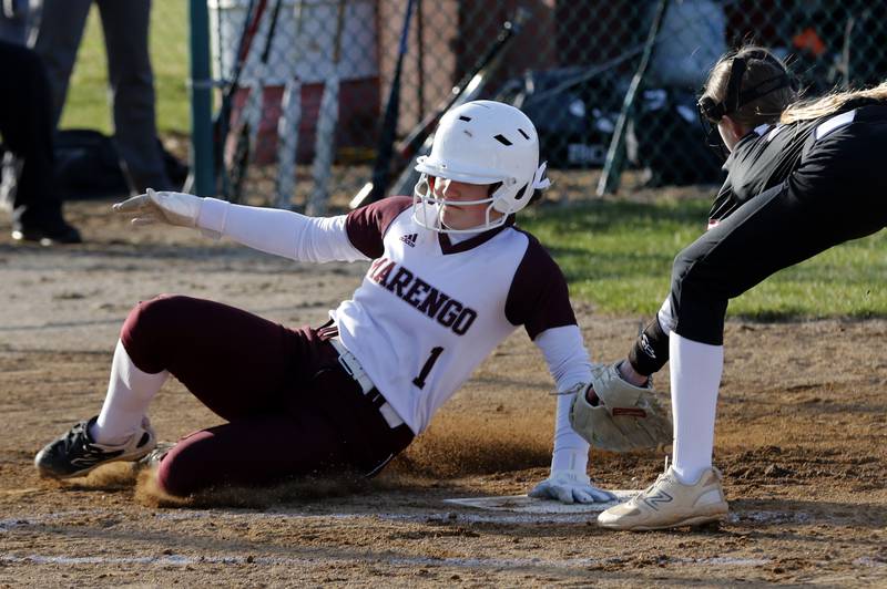 Marengo's Gabby Christopher slides into home plate in front of the tag by Antioch's Addison Osborne during a nonconference softball game on Monday, March 31, 2025, at Marengo High School.