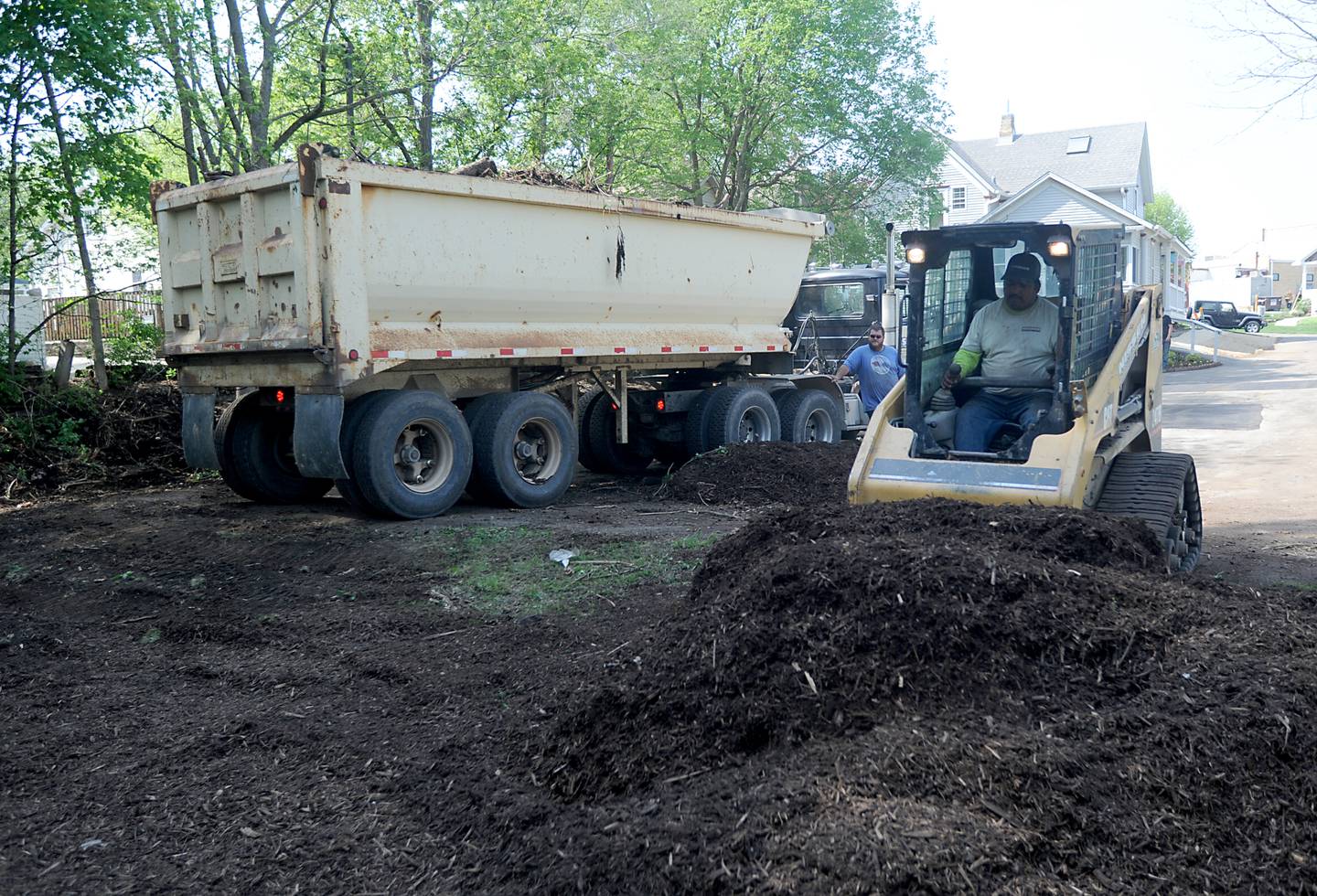 Mulch is installed by employees of Nissen Contractors, a trade partner of Lennar, on Friday, May 13, 2022, at the Kids in Need of McHenry County home, 55 E. Crystal Lake Ave. in Crystal Lake. About 70 employees of Lennar and their trade partners spent the day working on the home which is used for foster kids to interact with their biological parents in a more comfortable and natural setting.