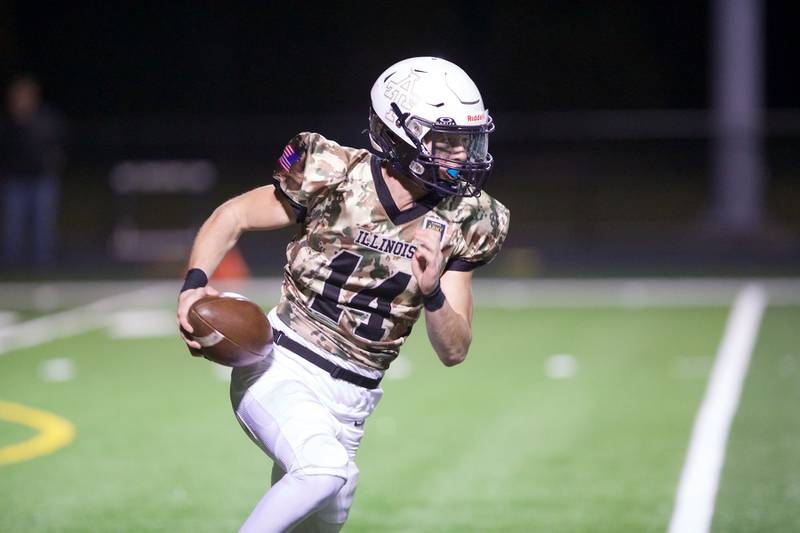 Addison Trails Nico Dill runs the ball  against Downers Grove South on Friday, Oct.25,2024 in Addison.