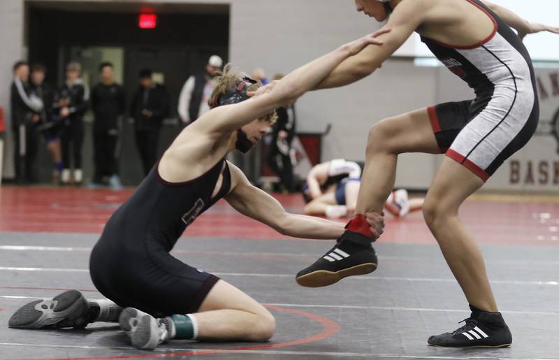 Prairie Ridge’s Jake Lowitzki tries to takedown Antioch’s Evan Jarczyk in a 120-pound match of the IHSA 2A Antioch Wrestling Regional on Saturday, Feb. 8, 2025, at Antioch High School.