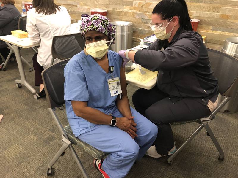 Hilary Robinson, a Silver Cross  registered nurse who works on 6-3 and has cared for many, many COVID patients throughout the pandemic.  receives a Pfizer COVID vaccine on Dec. 16.