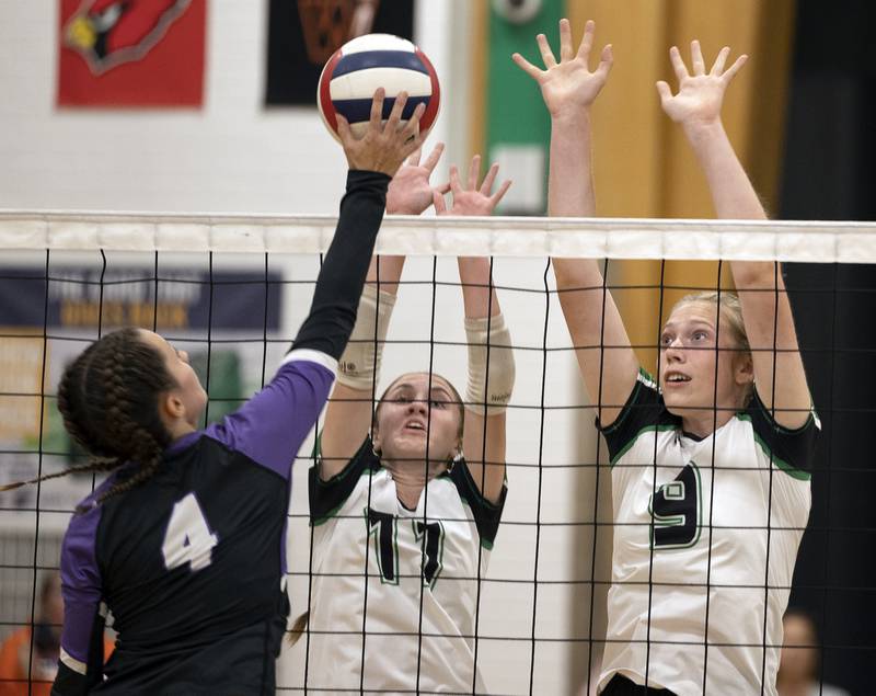 Rock Falls’ Miley Bickett (left) and Kayla Hackbarth work against Dixon’s Meredith Foulker Thursday, Sept. 19, 2024, in a Big Northern Conference match at RFHS.