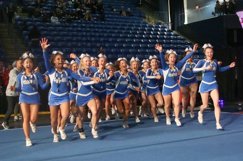 Members of the Burlington Central cheerleading team run to grab the second-place trophy at the Competitive Cheerleading State Final Competition on Saturday, Feb. 3, 2024 at Grossinger Motors Arena in Bloomnington.