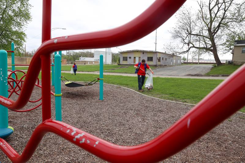 Volunteers Nicholas Scocozzo, right, and Lisa Hassett, with Dow Chemical in Kankakee, clean up Washington Park during the United Way of Kankakee & Iroquois Counties’ annual Day of Action on Wednesday, April 22, 2026.