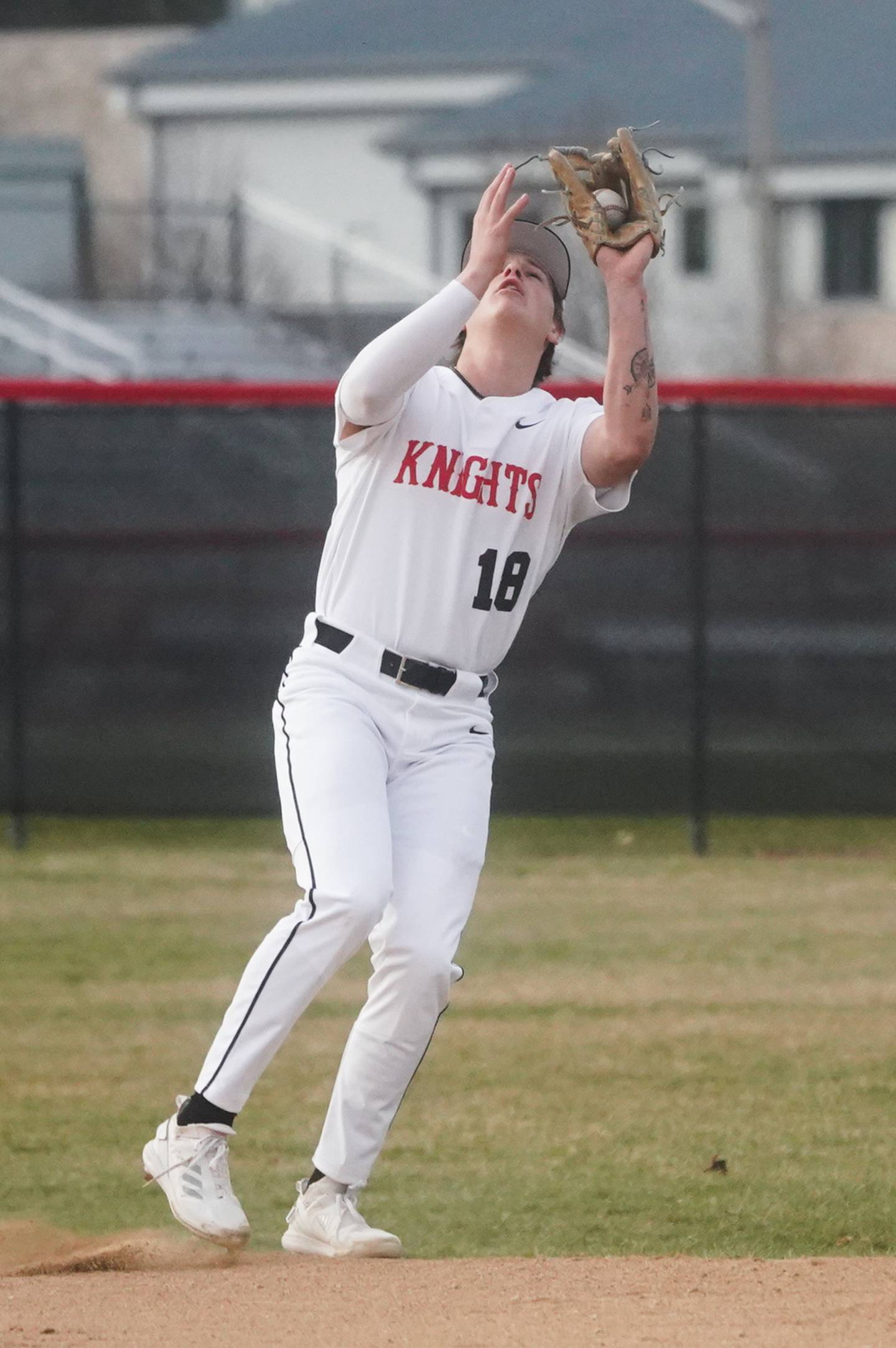 Lincoln-Way Central's Luke Mensik (18) catches a pop-up against Yorkville during a baseball game at Yorkville High School on Tuesday, March 12, 2024.