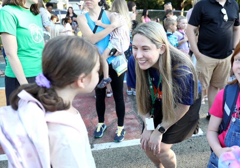 Second-grade teacher Jamie Arendas greets some of her students on the first day of school Friday, Aug. 16, 2024 at Kingsley Elementary School in Downers Grove.