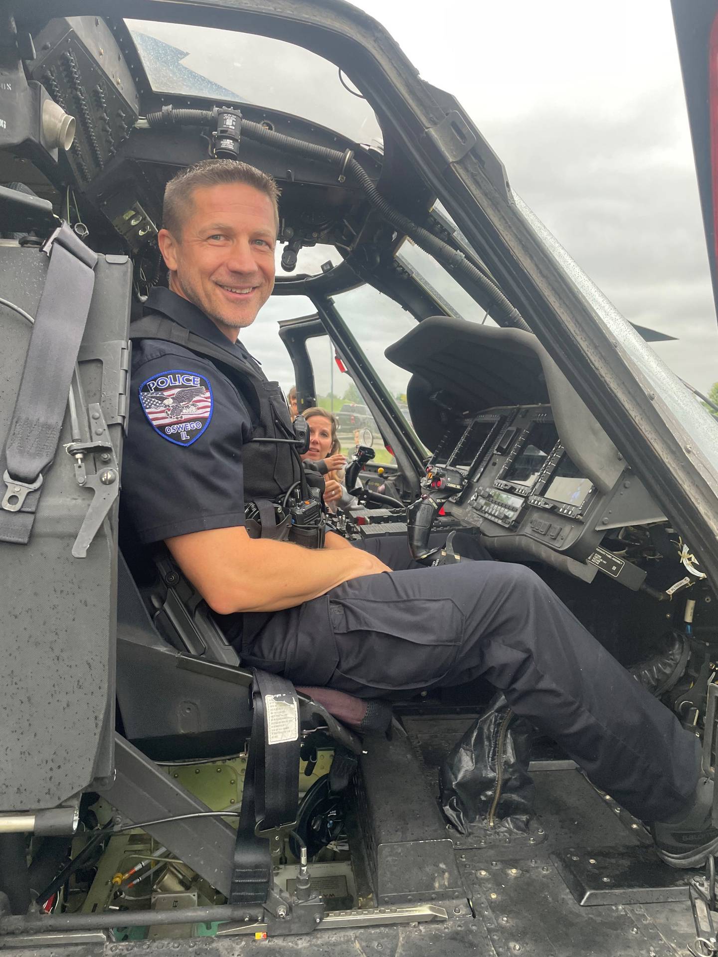 Oswego Police Deputy Chief Shane Yackley sits in a UH-60 Black Hawk helicopter during Oswego Police Department's National Night Out in August.