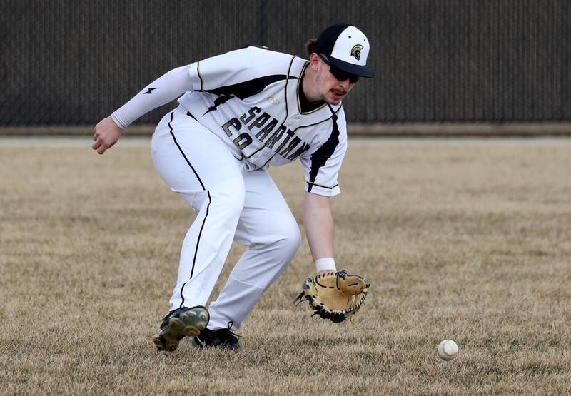 Sycamore's Devin Shaulis fields a ball in left field during their game against Byron Wednesday, March 26, 2025, at DeKalb High School. Sycamore’s home field was damaged in last week’s storms so today’s game was played on DeKalb’s field.