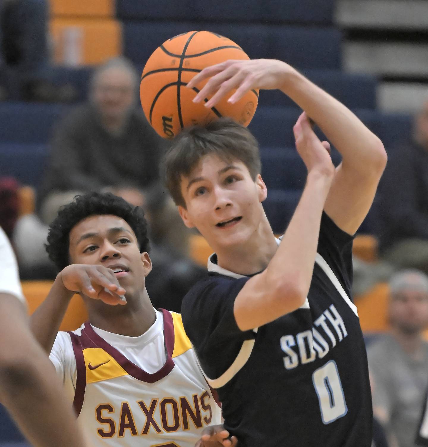 Downers Grove South’s Sean Day has the ball stripped by Schaumburg’s Aiden Patterson in a boys basketball game in Buffalo Grove on Friday, January 3, 2025.