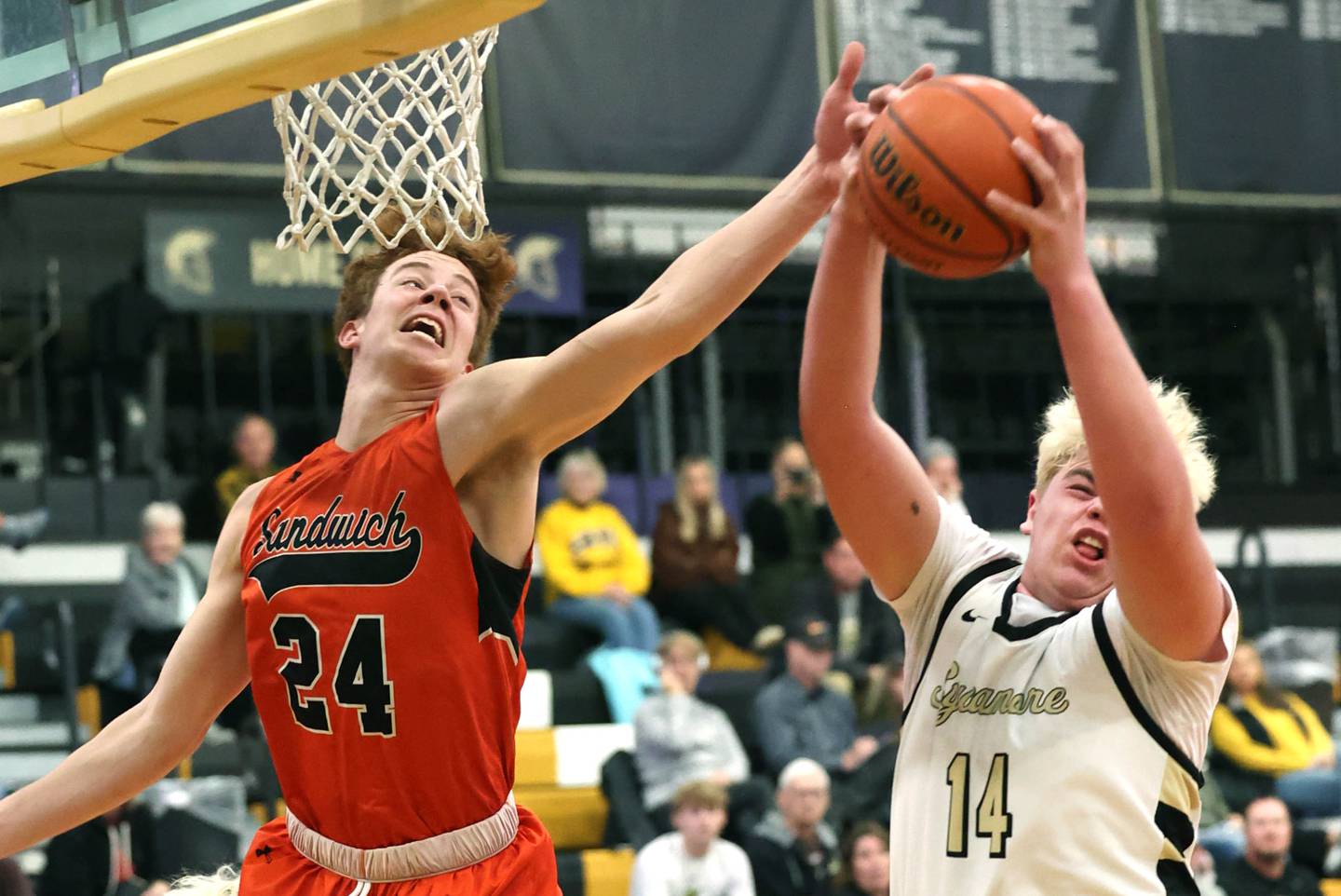 Sandwich's Dom Rome and Sycamore's Michael Chami go after a rebound during their game Friday, Nov. 24, 2023, in the Leland G. Strombom Holiday Tournament at Sycamore High School.