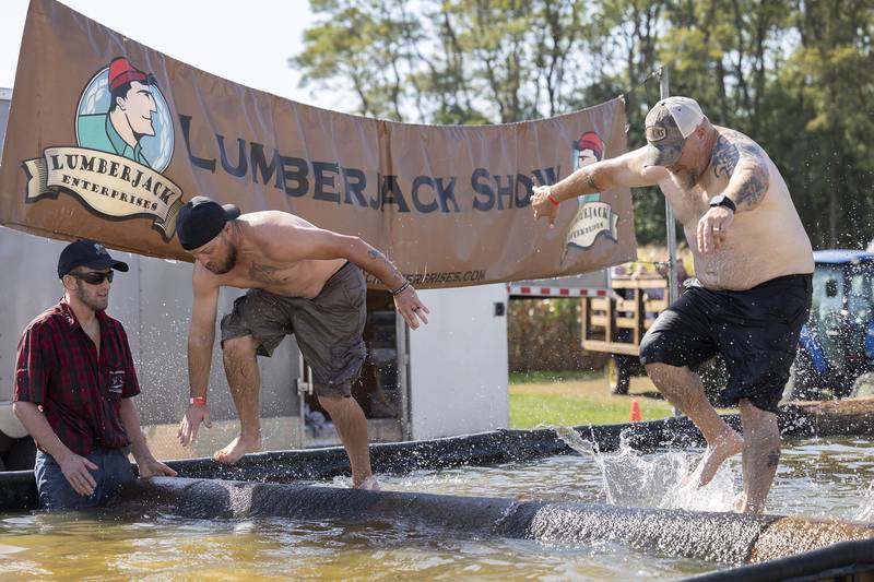 Not wanting the kids to have all the fun, Thomas Blink (left) and Jay Scribner attempt the log roll Saturday, October 5, 2024, at the Lumberjack Show.