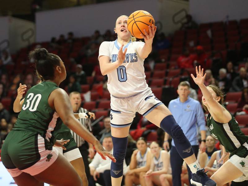 Cissna Park's Addison Lucht eyes the hoop over St. Edward's Jordin Sauls during the Class 1A third place game on Friday, March 7, 2025 at CEFCU Arena in Normal.