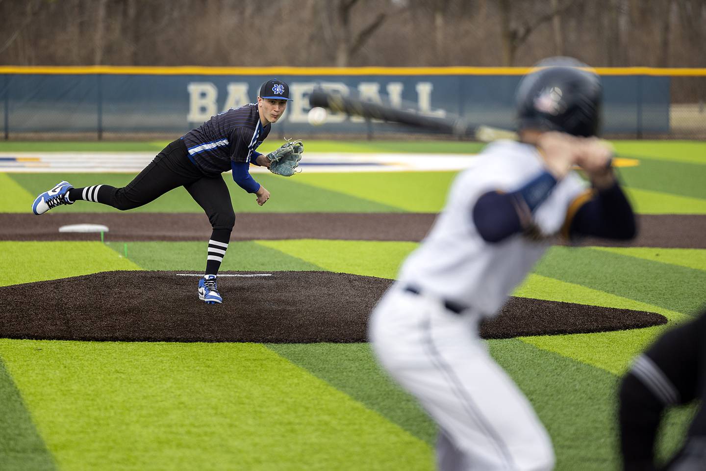 Newman’s Evan Bushman fires a pitch against Sterling Tuesday, March 18, 2025.