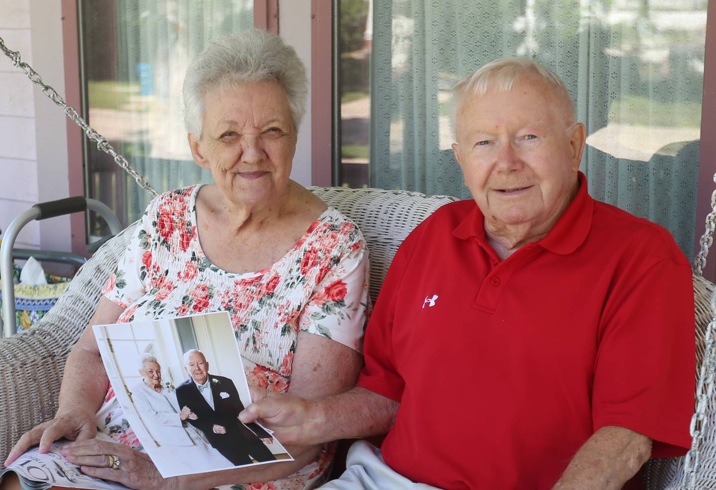 Loretta Volker and her husband Dick, pose while holding a photo of them at their sons wedding outside their home on Wednesday, Aug. 20, 2025 in Princeton. The Volkers have been married for 65 years.