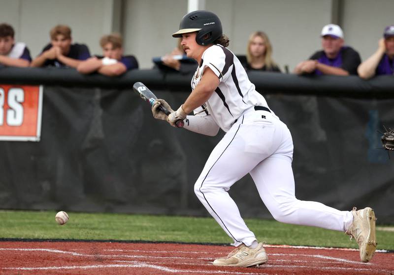 Sycamore's Tyler Lojko bunts for a single Thursday, May 29, 2025, during their Class 3A regional semifinal game against Dixon at Freeport High School.