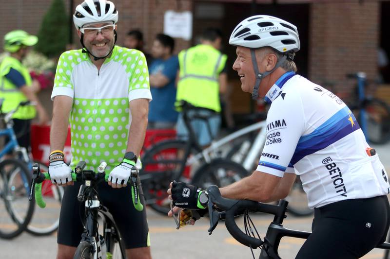 Christopher Morsch, left, of Algonquin visits with Kenneth Fejdasz, right, of Carpentersville before the Raue Center for the Arts Night Owl Bike Ride in Crystal Lake on Saturday, August 2, 2025.
