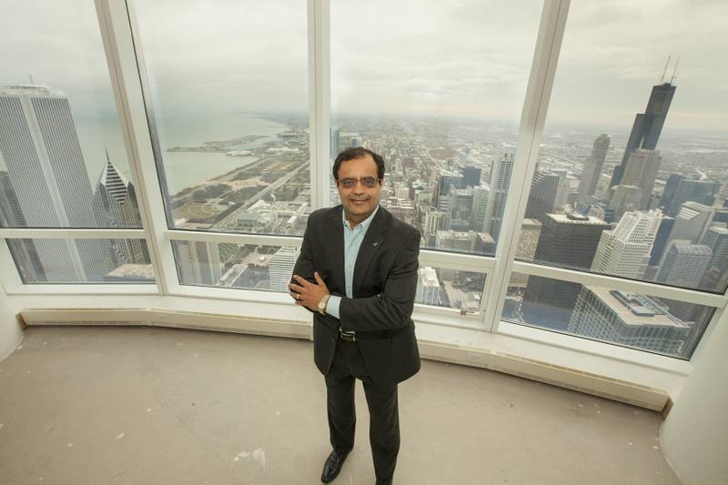 In this AP file photo, Sanjay Shah, founder and CEO of Vistex, Inc., appears after his purchase of the Trump International Hotel & Tower penthouse on Monday, December 8, 2014 in Chicago. (Photo by Barry Brecheisen/Invision/AP)