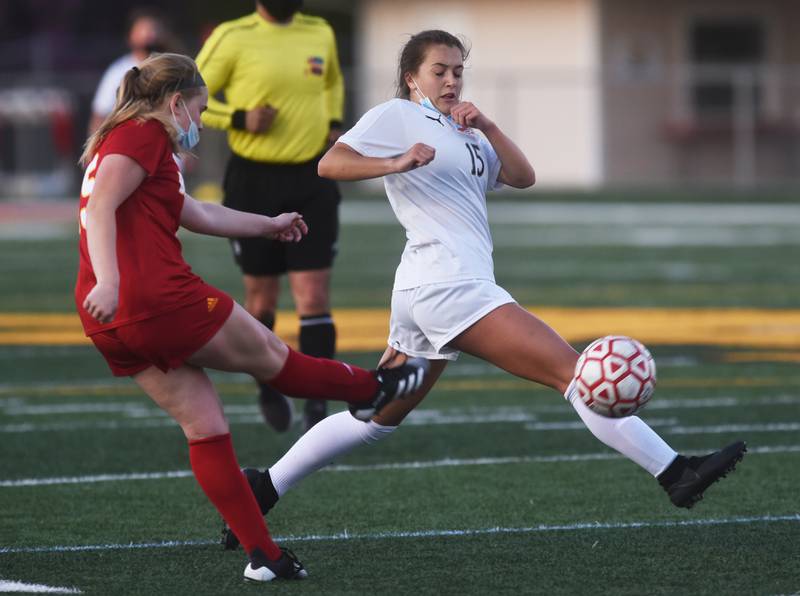 Wheaton Warrenville South's Emma Showman (15) tries to block a kick by Batavia's Bella Lins during Thursday's girls soccer game in Batavia.