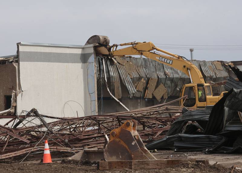 An excavator demolishes a portion of the Bill Walsh Coronet Dodge Chrysler Jeep RAM dealership on Tuesday, Feb. 17, 2026 in Peru.