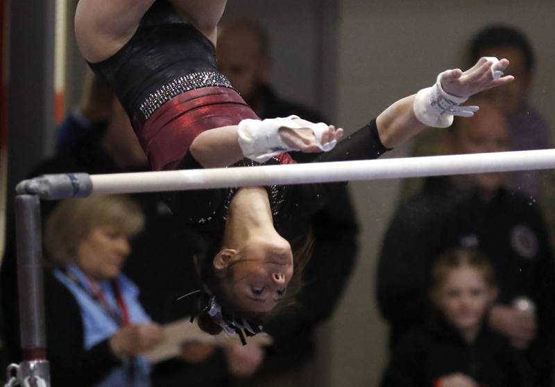 Prairie Ridge’s Gabby Riley competes in the of the uneven parallel bars Friday, Feb. 17, 2023, during the IHSA Girls State Final Gymnastics Meet at Palatine High School.