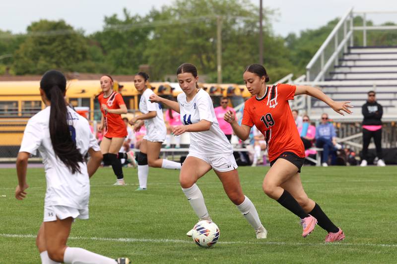Beecher's Ava Pattenaude (19) advances the ball against Peotone's Kiersten Bettenhausen during Peotone's 2-1 victory over Beecher in the Class 1A Manteno Regional championship on Friday, May 22, 2026.
