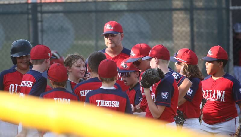 Members of the Ottawa American baseball team huddle in between innings while playing Streator All Stars during the District 20 championship game on Sunday, July 14, 2024 at Washington Park in Peru.