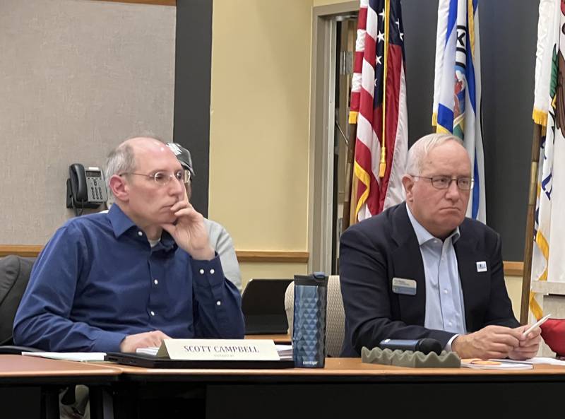 DeKalb County Board members Scott Campbell, left, a Democrat from District 7, and Tim Bagby, the head of the DeKalb County Republicans, listen during the public comment period of the Oct. 18, 2023 DeKalb County Board meeting.