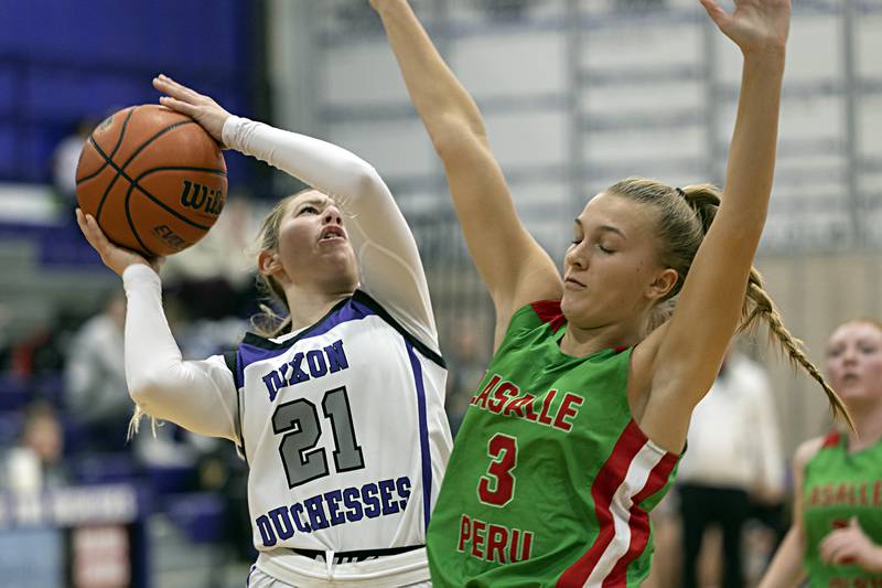Dixon’s Reese Dambman works below the basket against LaSalle-Peru’s Kaylee Abens Thursday, Nov. 30, 2023 in Dixon.