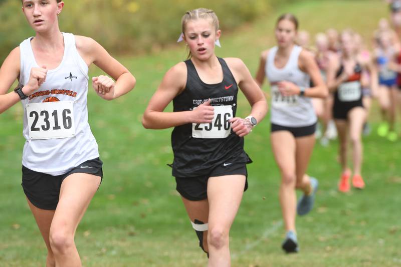 Erie-Propphetstown's Rozlyn Mosher (center) runs at the Amboy Columbus Day Cross Country Invitational held at Shady Oaks Country Club near Amboy on Monday, Oct. 13, 2025. She finished 25th.