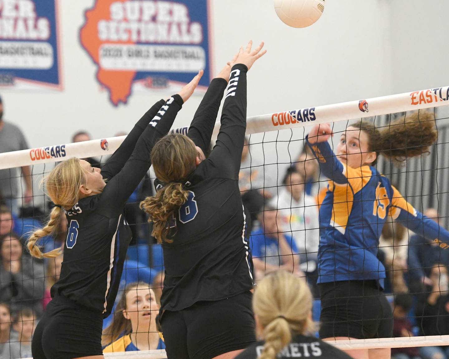 Newman's Jess Johns and Kennedy Rowzee blocks a hit by Southeastern's Amanda Stephens at the Eastland Supersectional on Friday, Nov. 4 in Lanark. The Comets won the match in two games.